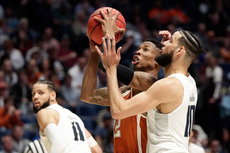 Texas guard Kerwin Roach II goes to the basket against Nevada forward Caleb Martin (10) in the second half of a first-round game of the NCAA college basketball tournament in Nashville, Tenn., Friday, March 16, 2018.